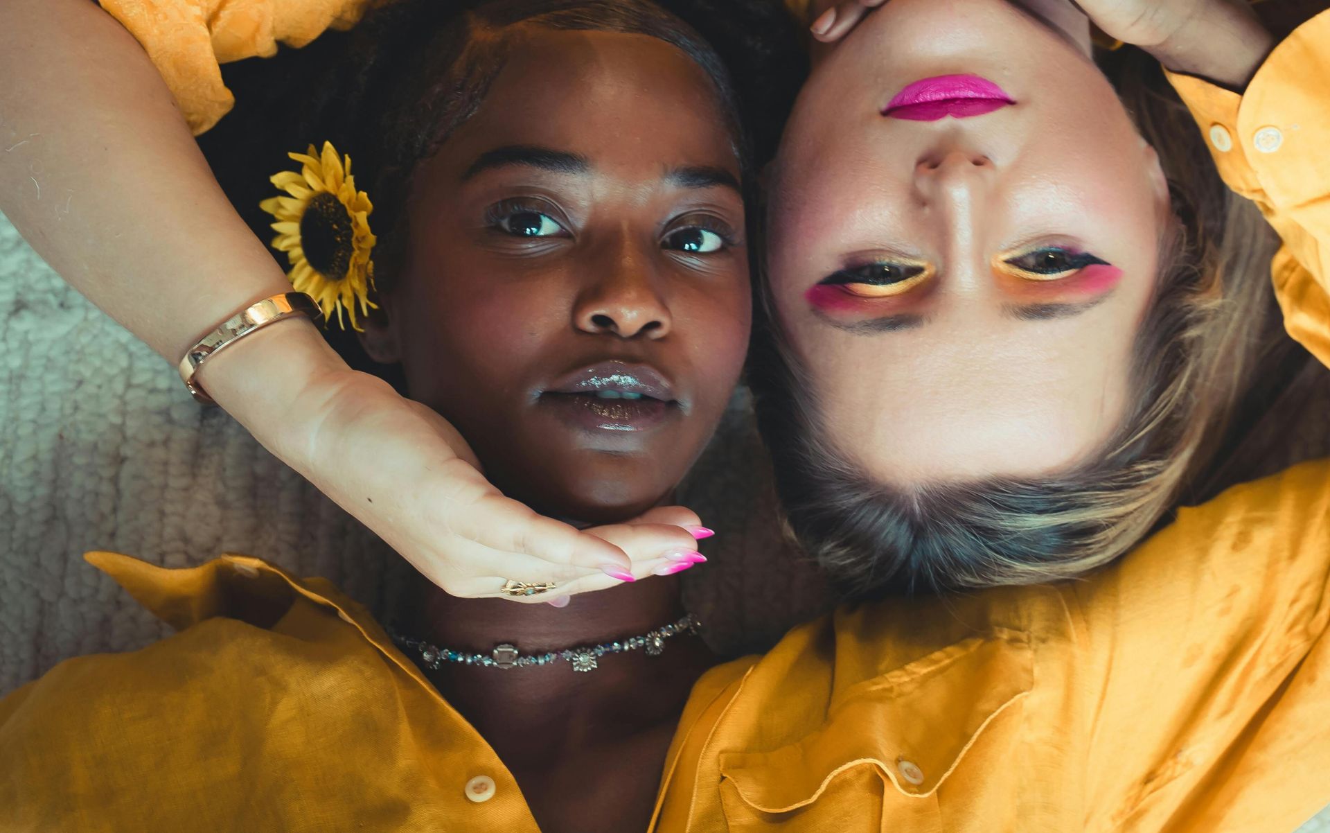 Artistic portrait of two women in yellow attire, showcasing vibrant fashion and beauty.